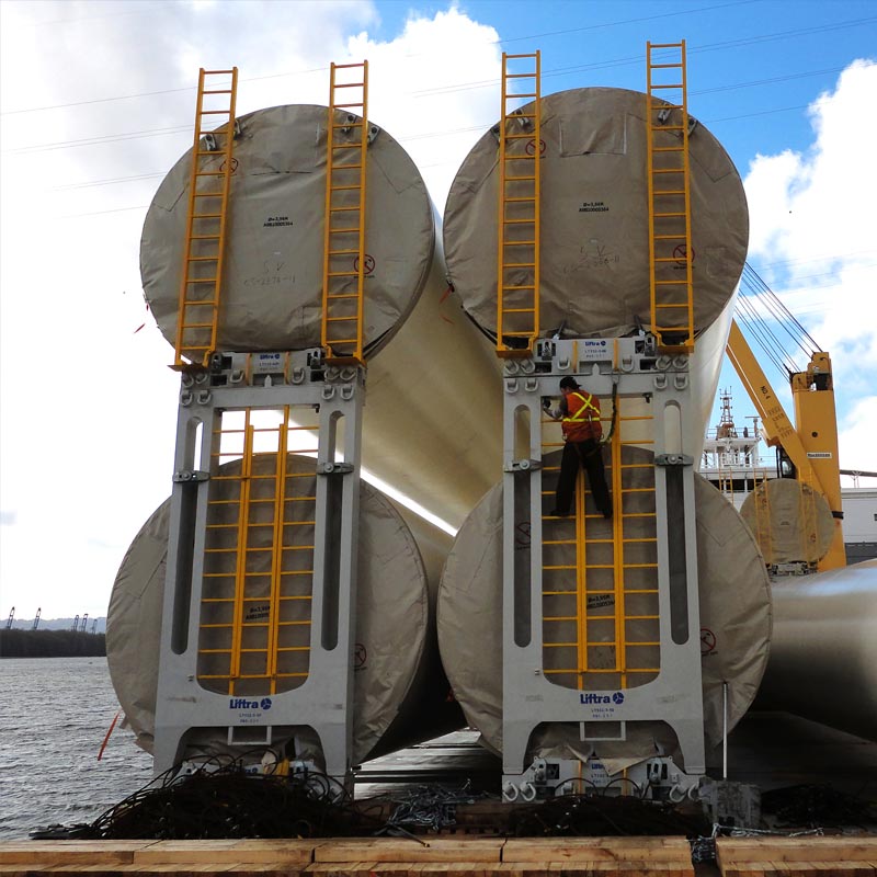 Tower stacking frames for sea transport of wind turbine towers